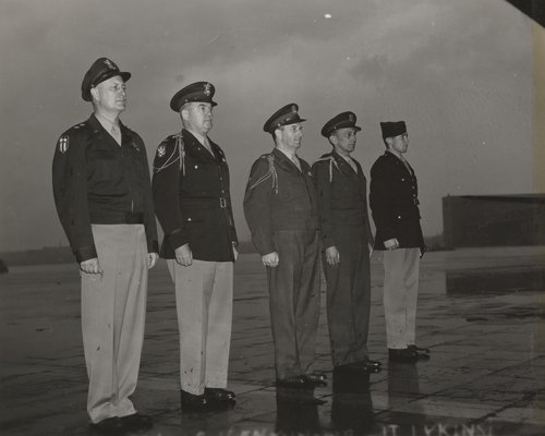 Five Airmen standing in formation.