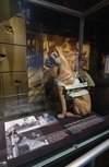A dog mannequin displaying Vittles' parachute in a museum.