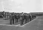 Around 50 high-ranking military representatives inspect the parade, saluting in places.