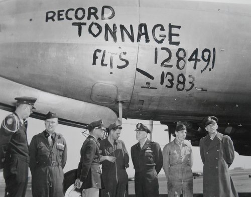 Beside the plane, American officers greet the flight crew after one of the last Easter Parade landings in Tempelhof.