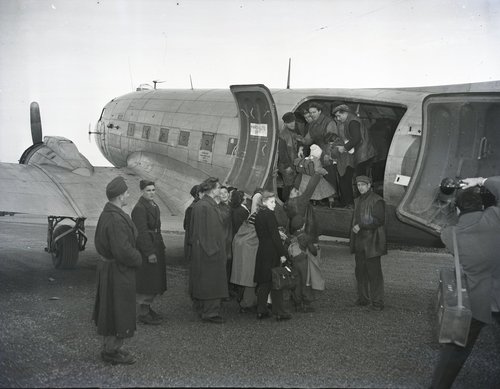 Children board an airplane