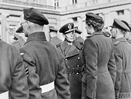 A group of men and a woman in RAF uniform.