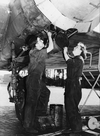 A female maintenance worker examines an aircraft engine.